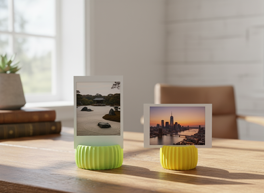Two small yellow lamps with photo holders on a wooden surface, displaying scenic images.