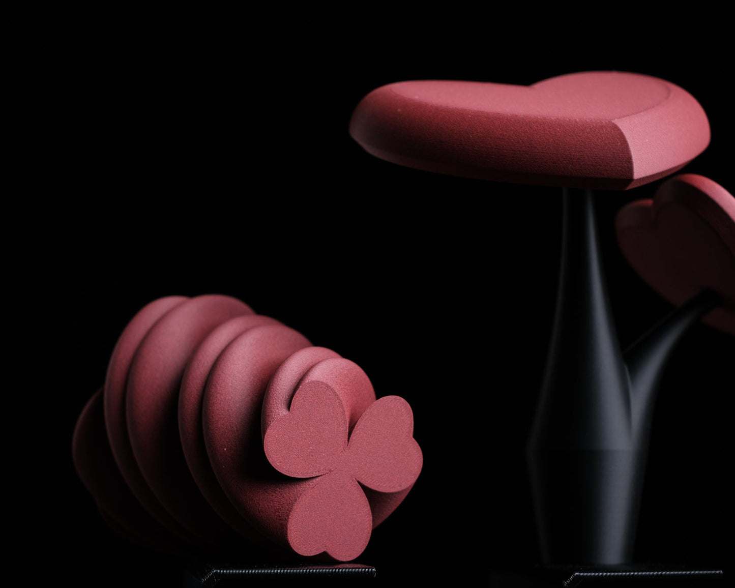 Pink floral-shaped object on a black background with 'h310 design' logo.