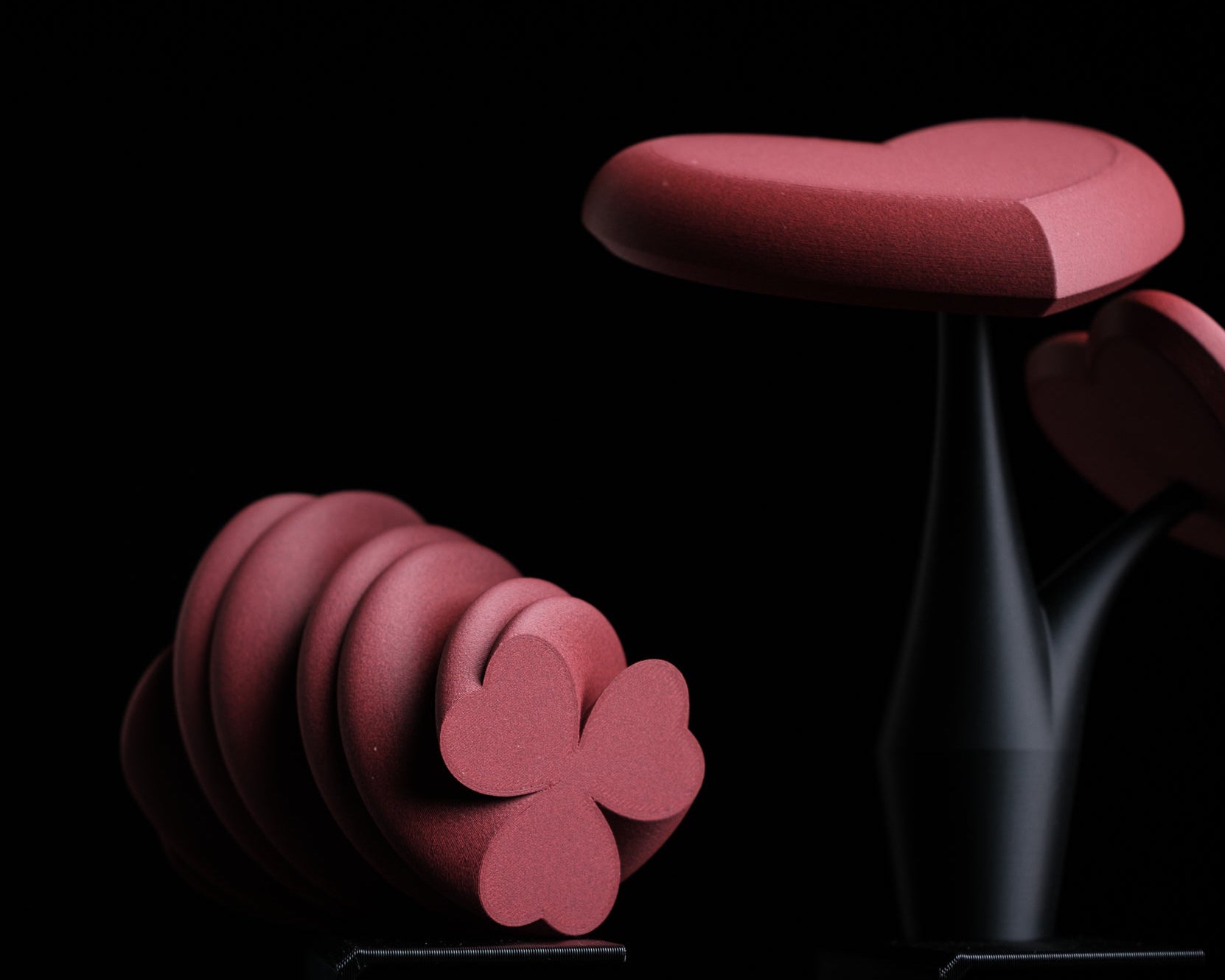 Pink floral-shaped object on a black background with 'h310 design' logo.