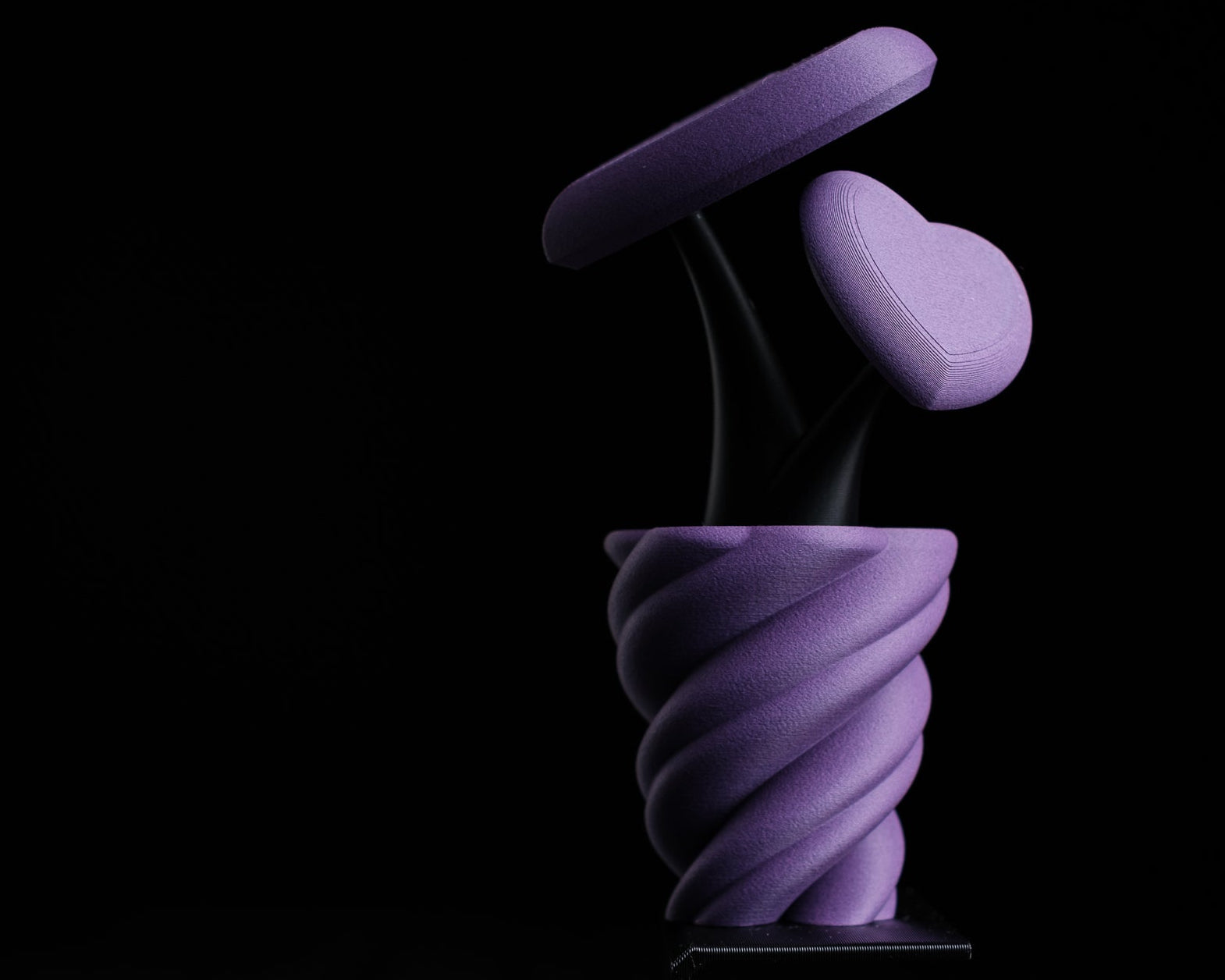 Purple spiral object on a black background with 'h3io design' logo.