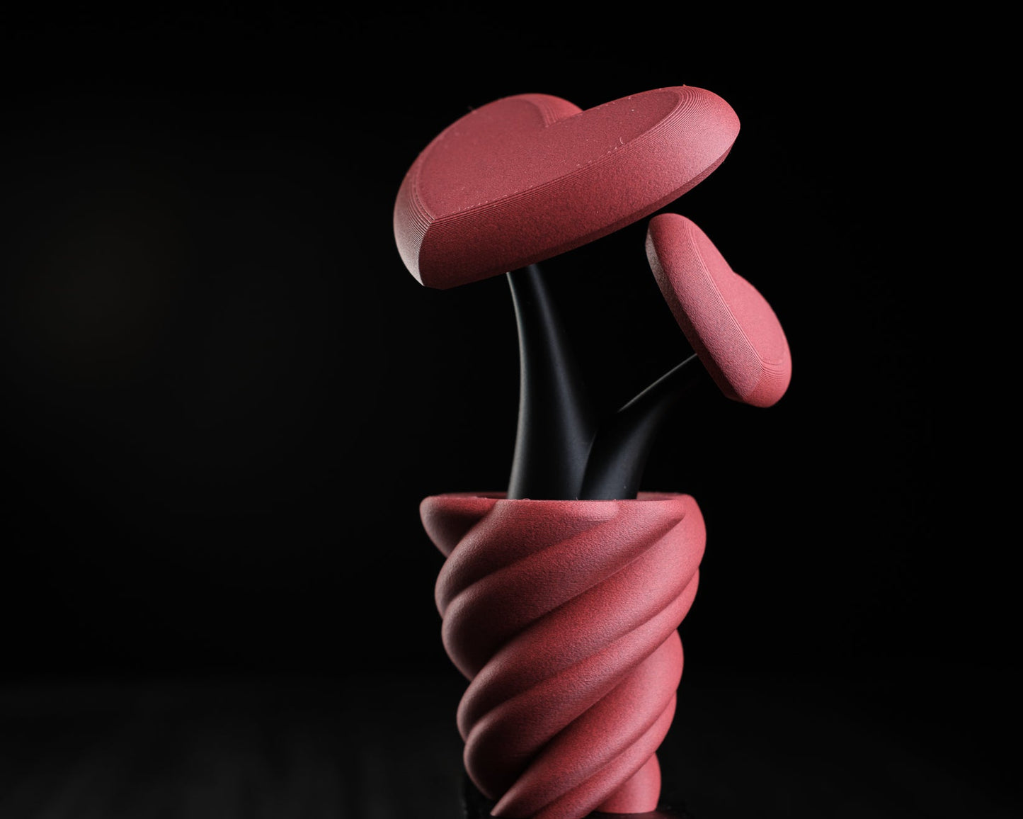 Pink abstract sculpture on a black background