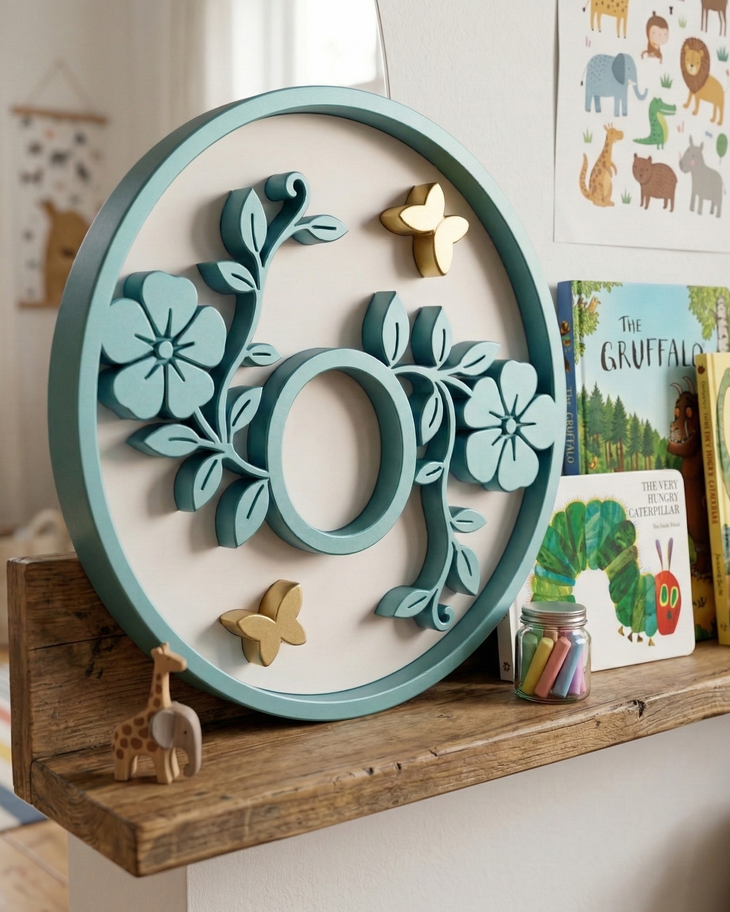 Decorative letter o piece with floral design on a shelf in a child's room
