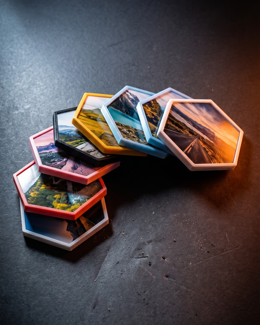 Hexagonal tiles with scenic images on a dark surface